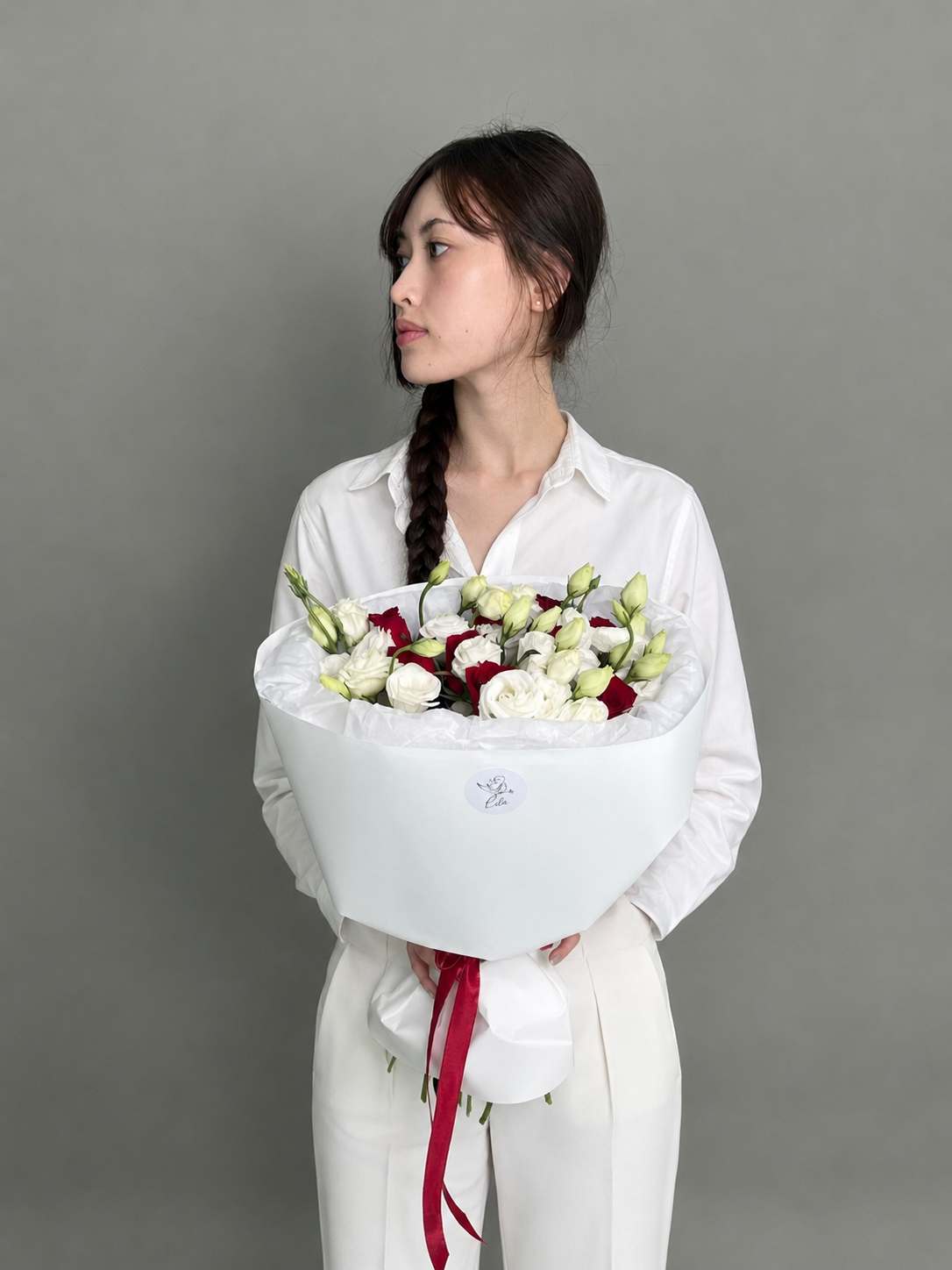 A bouquet of red roses and eustoma. Size M
