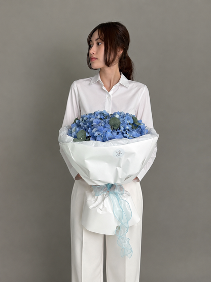 3 blue hydrangeas with eucalyptus