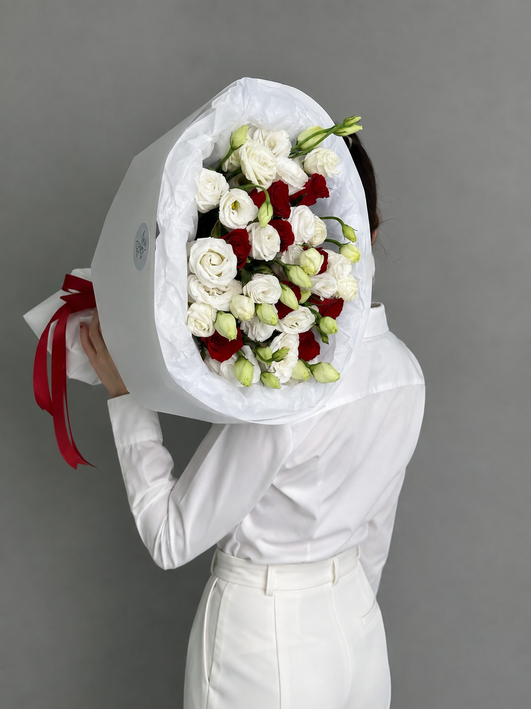 A bouquet of red roses and eustoma. Size M
