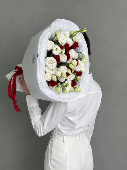A bouquet of red roses and eustoma. Size M