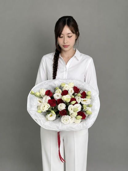 A bouquet of red roses and eustoma. Size M