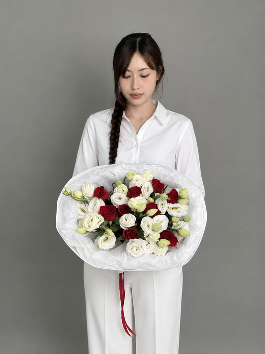 A bouquet of red roses and eustoma. Size M