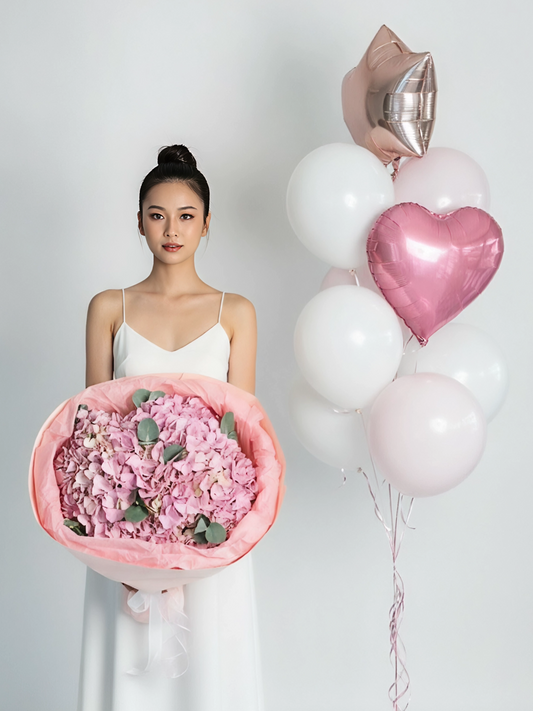 A bouquet of pink hydrangeas and a set of balloons